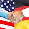 Händeschütteln vor den Flaggen der USA und Deutschlands