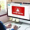 System hacked alert on computer screen after cyber attack on net