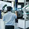 Ingenieur testet 'smart 3D glasses' und scannt mittels Joystick die Programming eines automatisierten Roboters industry in der 'smart factory'.
