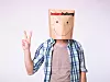 Unknown man showing victory sign with a paper bag on his head on white background, Instandhaltung