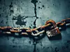 A metal chain is lying on a grunge background, representing the idea of breaking free from limitations and restrictions