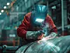 Welder at work in an industrial plant, using multi-process welding techniques on a pressure vessel.